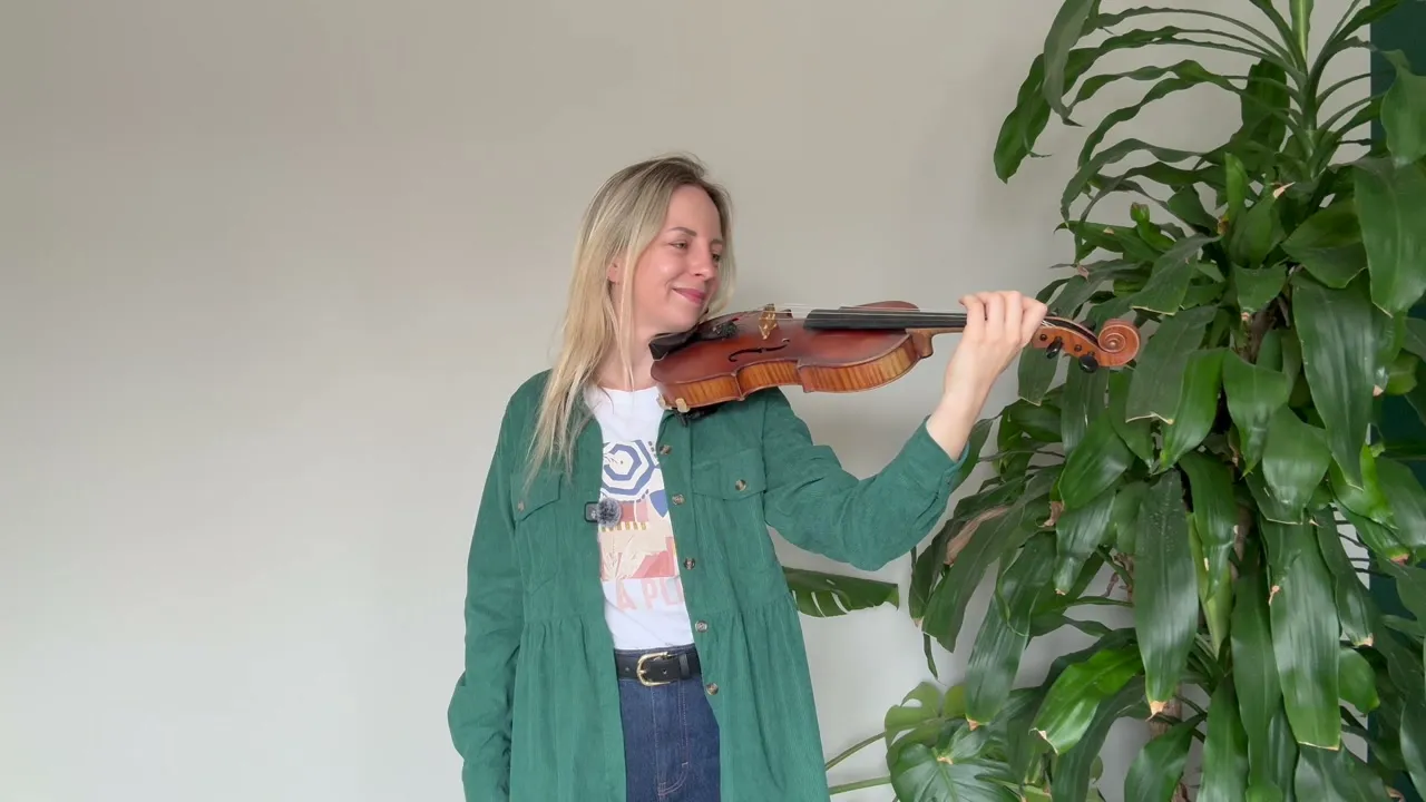 Marta demonstrating violin technique in a beginner lesson